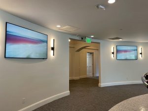 Multiple TVs on wall in office